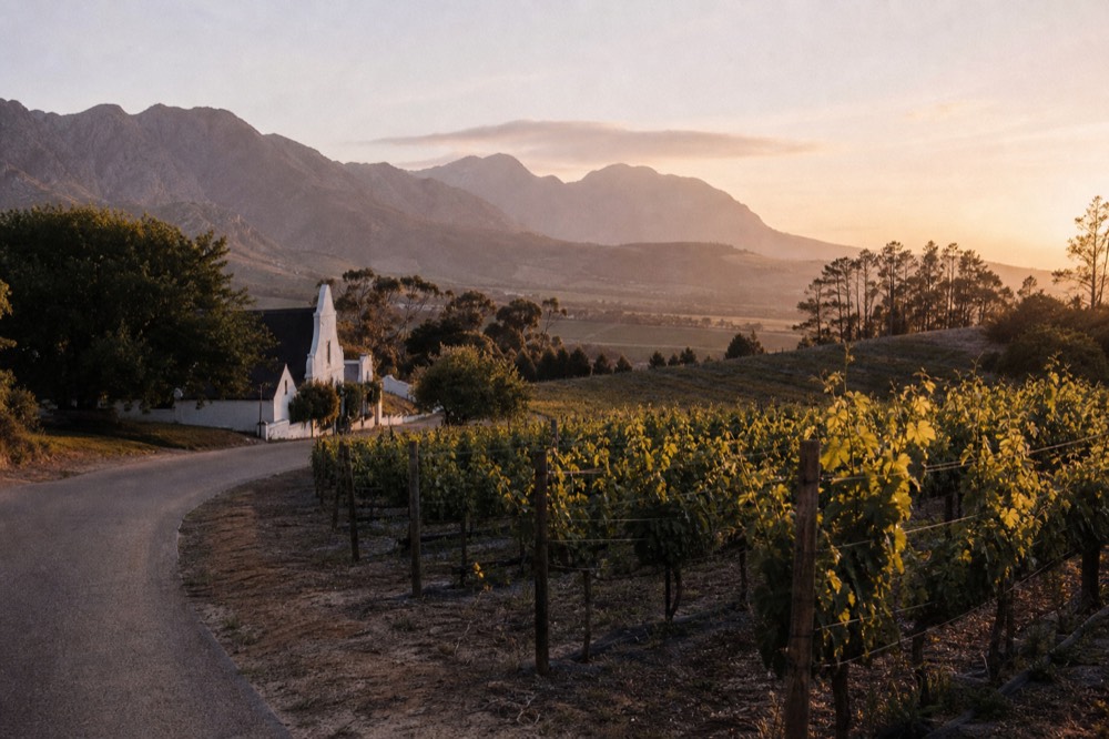 Mountain pass road winding toward Franschhoek valley, no text, no logos, no people